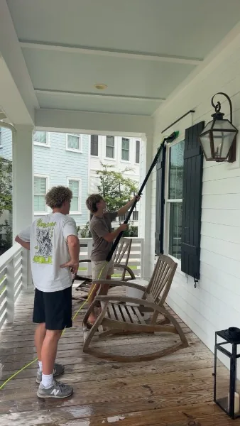 Clear Current cleaning an exterior window on a porch