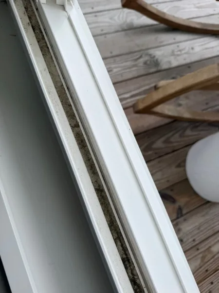 Window track before cleaning with visible dirt and buildup