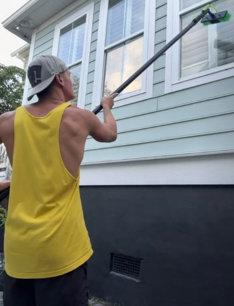Clear Current technician cleaning exterior windows
